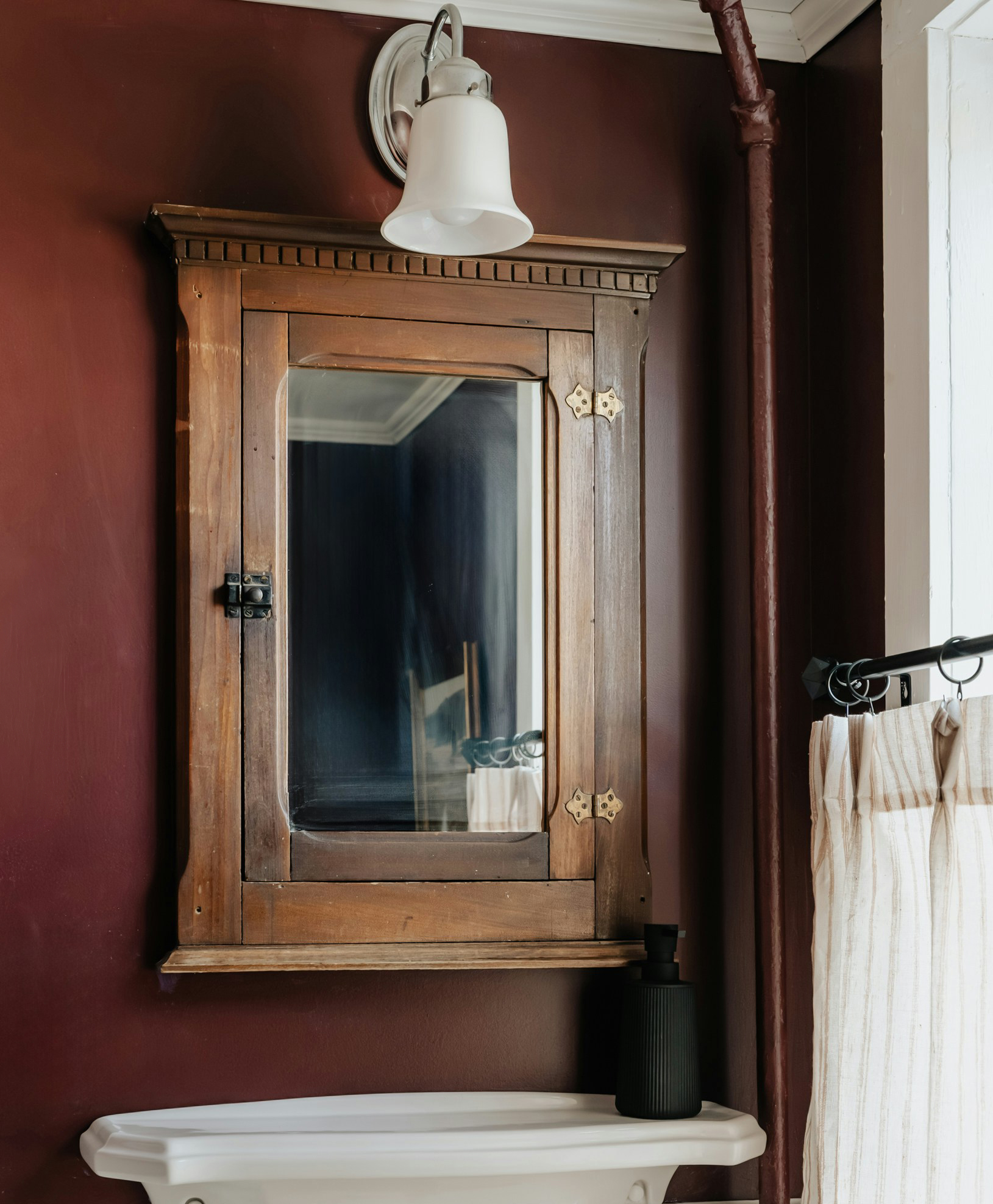 Photo of a bathroom cabinet with a mirror and sink.